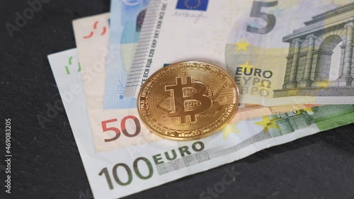 a man's hand in white gloves throws bitcoin on euro bills