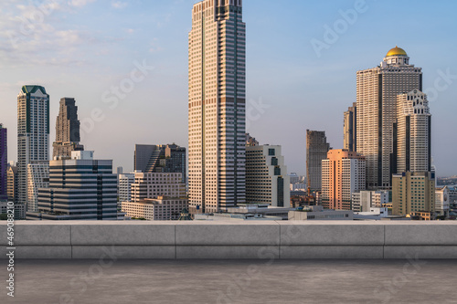 Panoramic Bangkok skyline view  concrete observatory deck on rooftop  sunset. Luxury Asian corporate and residential lifestyle. Financial city downtown  real estate. Product display mockup empty roof