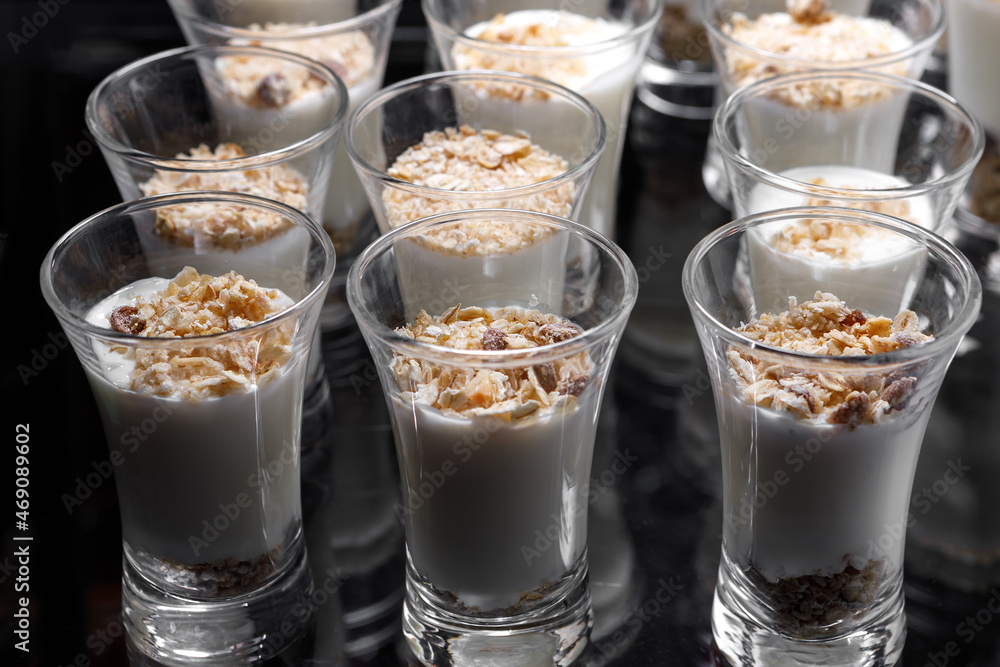 Creamy dessert of nuts in a glass stack on a dark background. Creamy dessert of nuts in a glass stack on a dark background.