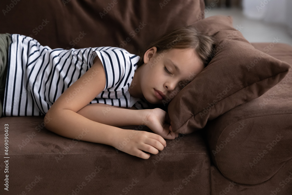Close up little girl taking day nap sleeping on cozy comfortable