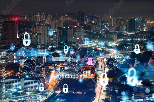 Glowing padlock hologram, night panoramic city view of Kuala Lumpur, Malaysia, Asia. The concept of cyber security shields to protect KL companies. Double exposure.