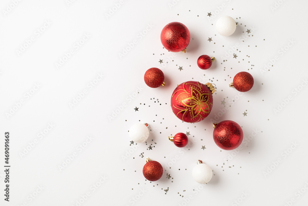 Top view photo of red and white christmas tree decorations balls with gold flower pattern and silver sequins on isolated white background with empty space Top view photo of red and white christmas tree decorations balls with gold flower pattern and silver sequins on isolated white background with empty space