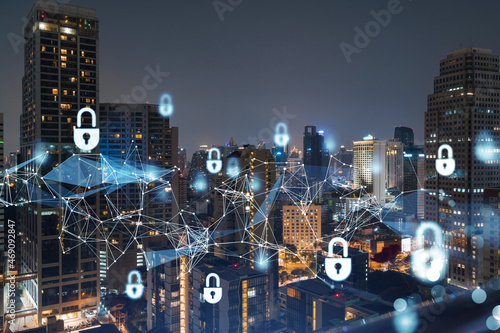 Glowing Padlock hologram, night panoramic city view of Bangkok, Southeast Asia. The concept of cyber security to protect companies. Double exposure.