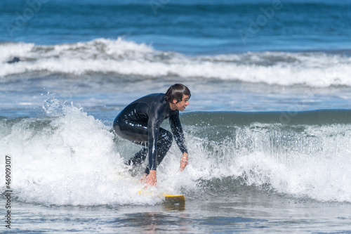 surfing the wave in the beach of La Serena, Chile