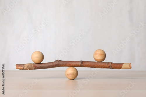 Tree branch with wooden balls on table, space for text. Harmony and balance concept