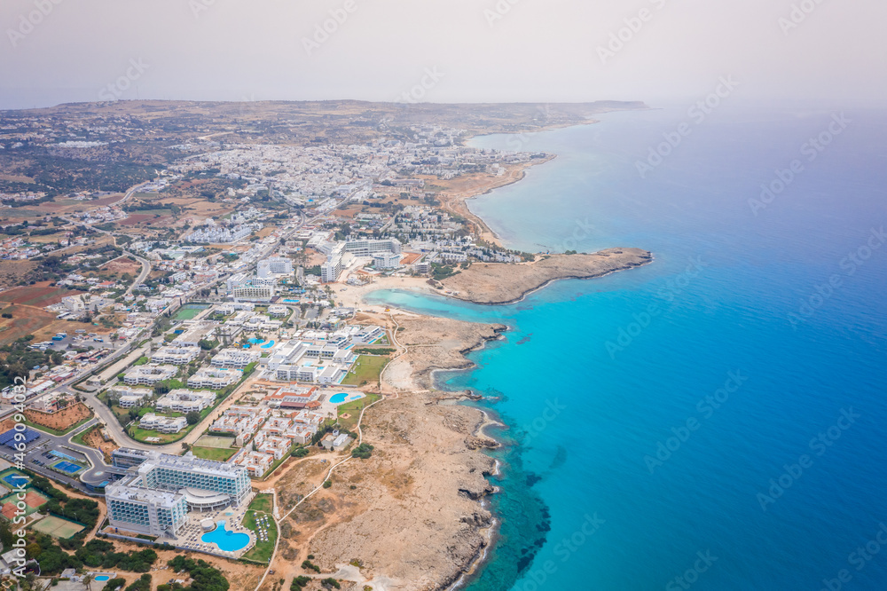 Aerial view of the most famous beaches in Cyprus - Nissi Beach. White sand beach with azure waters. Beautiful beach and panoramic views of the Cyprus coastline