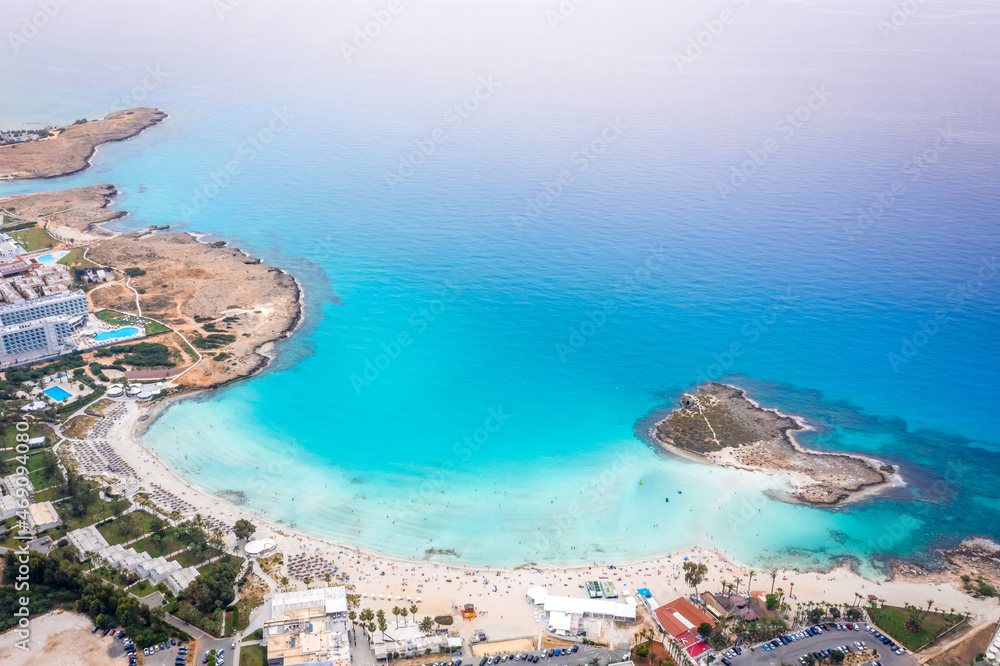 Naklejka premium Aerial view of the most famous beaches in Cyprus - Nissi Beach. White sand beach with azure waters. Beautiful beach and panoramic views of the Cyprus coastline