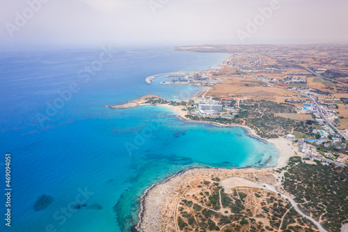 Aerial view of the most famous beaches in Cyprus - Nissi Beach. White sand beach with azure waters. Beautiful beach and panoramic views of the Cyprus coastline