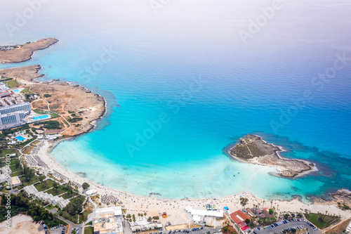 Aerial view of the most famous beaches in Cyprus - Nissi Beach. White sand beach with azure waters. Beautiful beach and panoramic views of the Cyprus coastline photo
