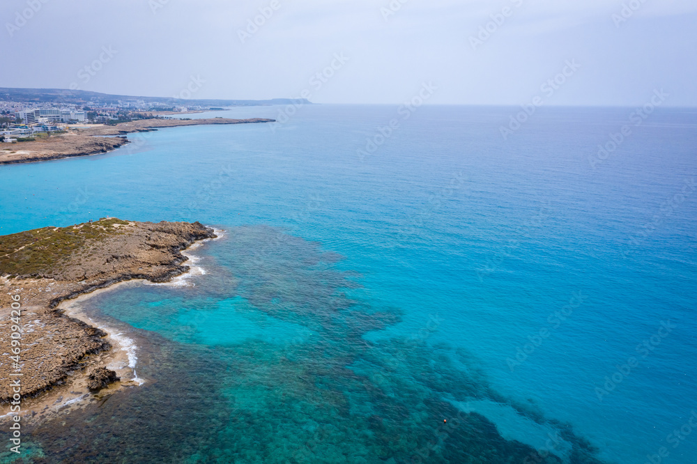 Aerial view of the most famous beaches in Cyprus - Nissi Beach. White sand beach with azure waters. Beautiful beach and panoramic views of Cyprus