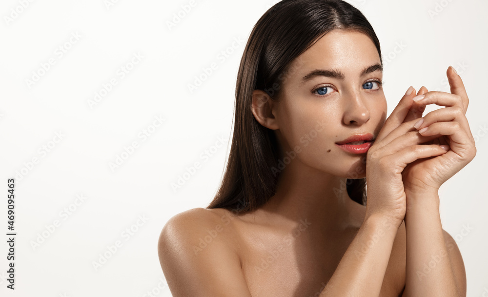 Skin care and spa. Young woman with healthy hair and glowing body skin, touching her face without makeup, concept of skincare cleansing products, white background Skin care and spa. Young woman with healthy hair and glowing body skin, touching her face without makeup, concept of skincare cleansing products, white background