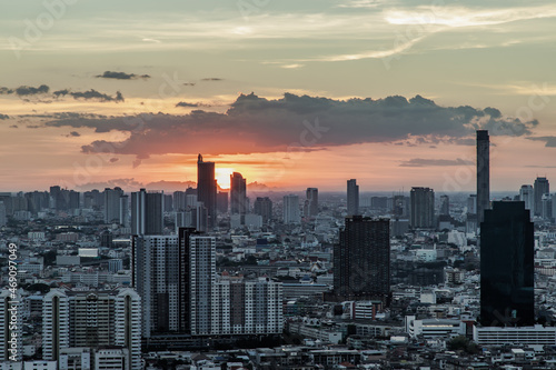Gorgeous panorama scenic of the sunrise with cloud on the orange sky over large metropolitan city in Bangkok. Copy space  Selective focus.