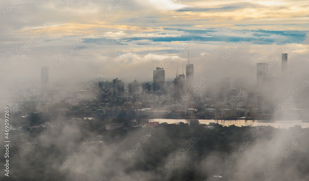 Bangkok, thailand -Sep 16, 2021 : An impressive aerial top view of skyscrapers at downtown Bangkok city along the chao phraya river in morning fog. No focus, specifically. Bangkok, thailand -Sep 16, 2021 : An impressive aerial top view of skyscrapers at downtown Bangkok city along the chao phraya river in morning fog. No focus, specifically.