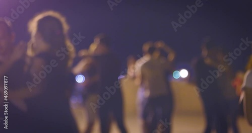Dancing fiesta in a night.Many couples dance Latin-American social dances.Open-air music festival.Young people enjoy open-air salsa or samba dancing festival.Defocused couples dancing salsa in street
