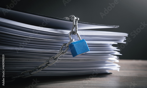 Documents locked with padlock and chains. photo