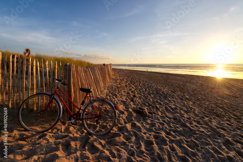 Bicycle, sand dune, beach and sun in Cotentin coast. Hauteville-sur-Mer village