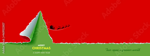 Christmas red rapper tearing open a green background. A Silhouette of Santa Claus riding a herd of deer.