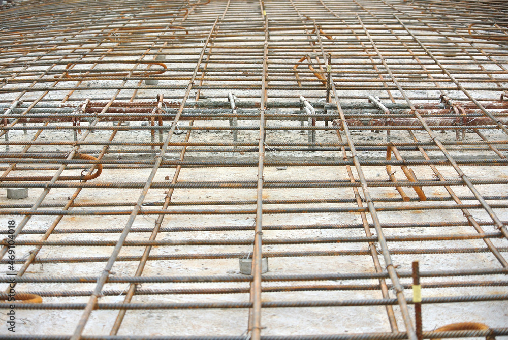 SELANGOR, MALAYSIA -MAY 13, 2016: Hot rolled deformed steel bars or steel reinforcement bars used at the construction site to strengthen concrete. It is shaped to follow the engineer's design. SELANGOR, MALAYSIA -MAY 13, 2016: Hot rolled deformed steel bars or steel reinforcement bars used at the construction site to strengthen concrete. It is shaped to follow the engineer's design.