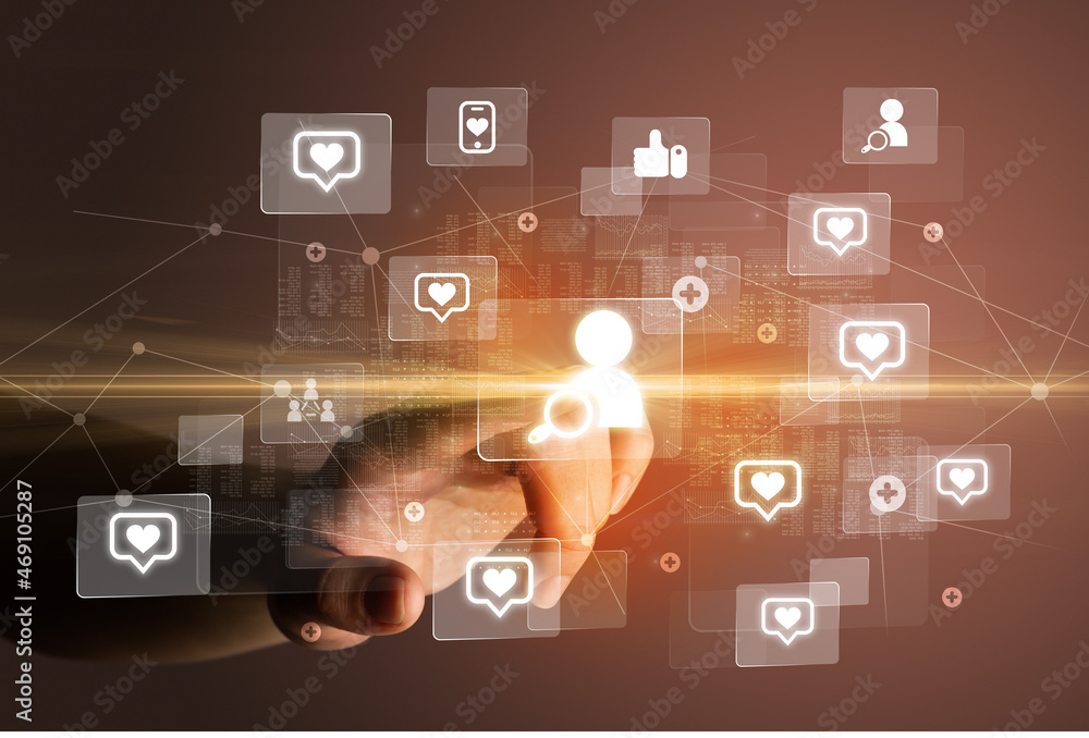 Hand pressing social media multimedia application screen with media icons on futuristic concept Hand pressing social media multimedia application screen with media icons on futuristic concept