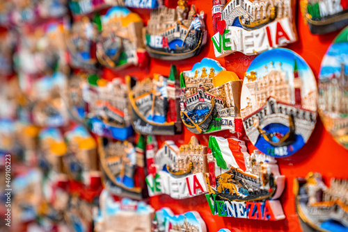 Colorful travel destination magnet souvenirs displayed in a row to sell to tourists © Aerial Film Studio