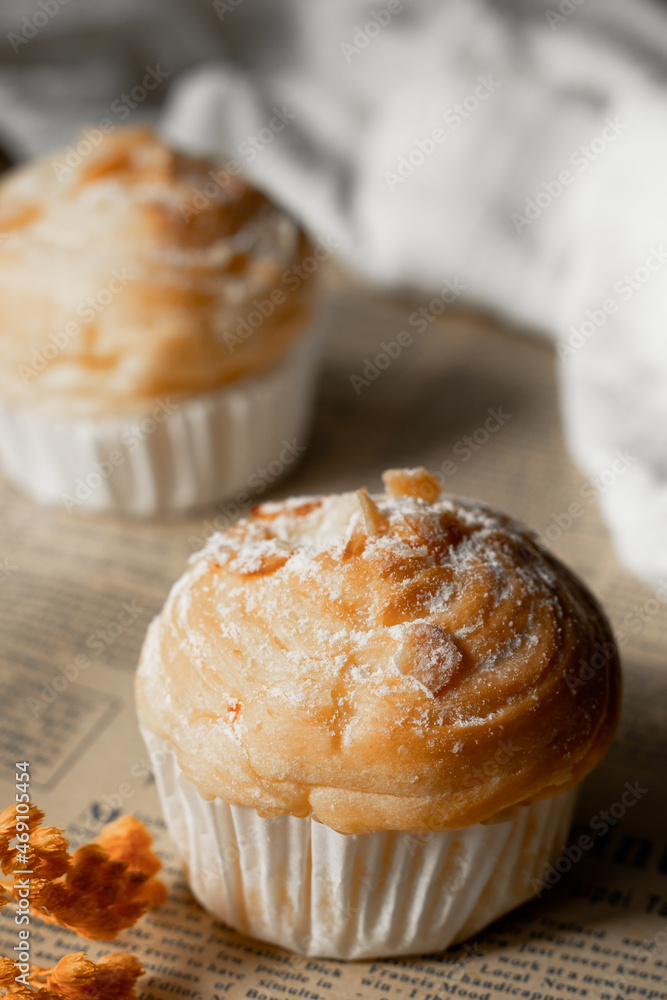 Delicious modern cruffins are made from layered croissants in the shape of a muffin Shaped like a cupcake. topping almond.