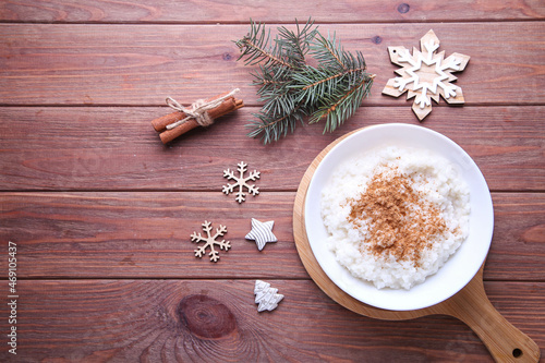 Christmas cinnamon rice pudding on a wooden background with place for text.