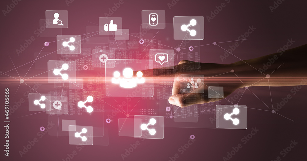 Hand pressing social media multimedia application screen with media icons on futuristic concept Hand pressing social media multimedia application screen with media icons on futuristic concept