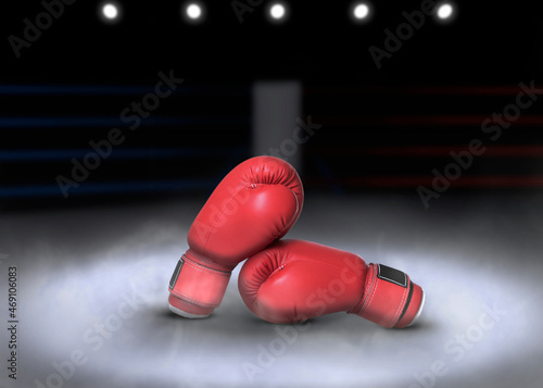 Pair of boxing gloves on ring in darkness