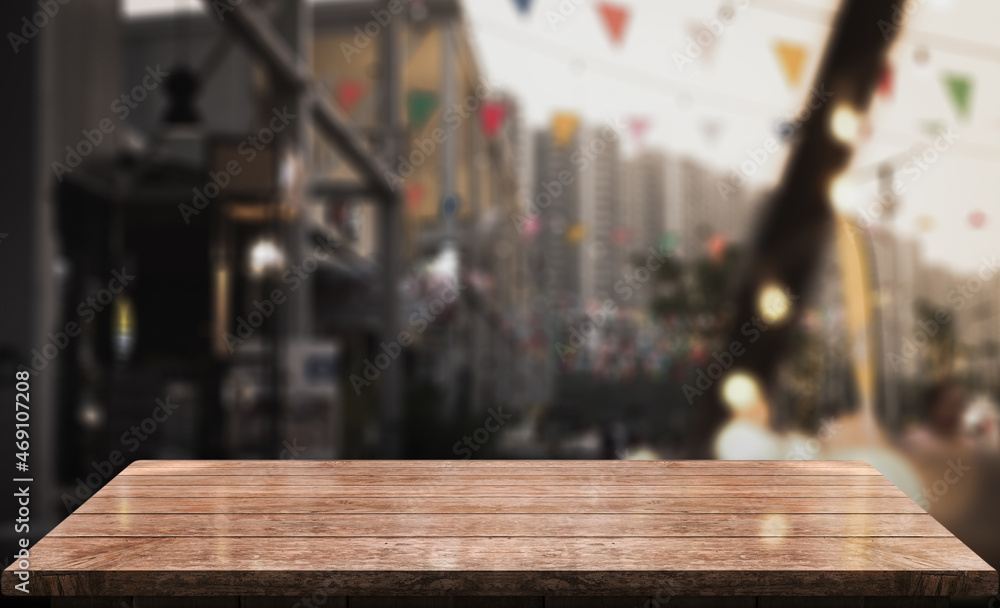 Empty wooden table top with lights bokeh on blur restaurant background. Empty wooden table top with lights bokeh on blur restaurant background.