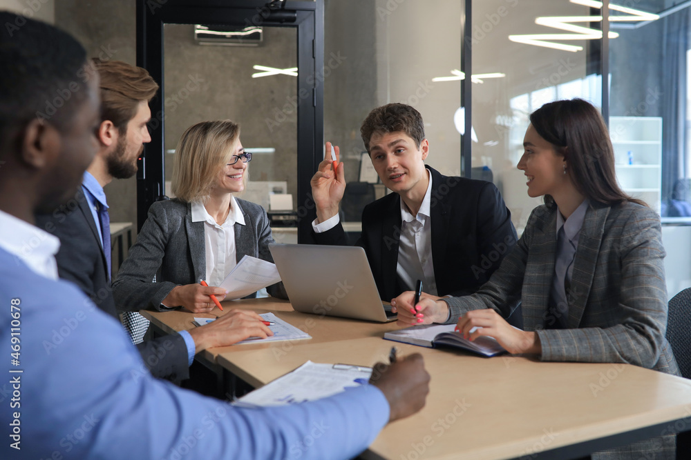 Group of happy young business people in a meeting at office. Group of happy young business people in a meeting at office.