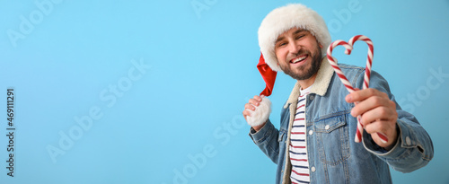 Handsome man in Santa hat a...