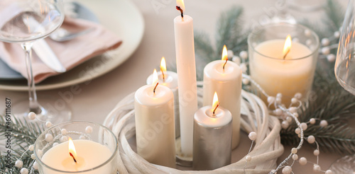 Beautiful table setting with candles for Christmas dinner