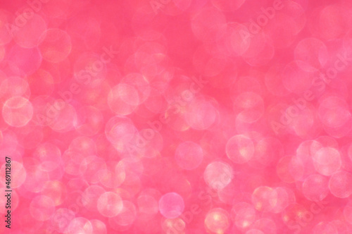 Blurred background with round bokeh. Bright pink bokeh in pattern. Bright ligts. Abstract blurred background..