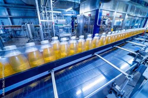 Conveyor belt with bottles for juice or water at a modern beverage plant