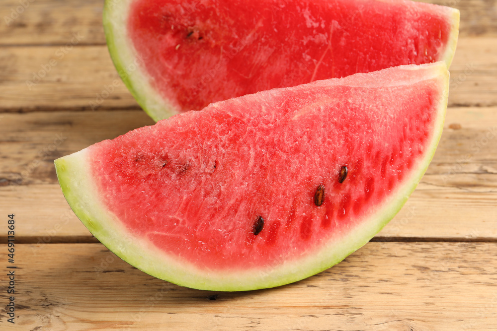 Delicious fresh watermelon slices on wooden table, closeup Delicious fresh watermelon slices on wooden table, closeup