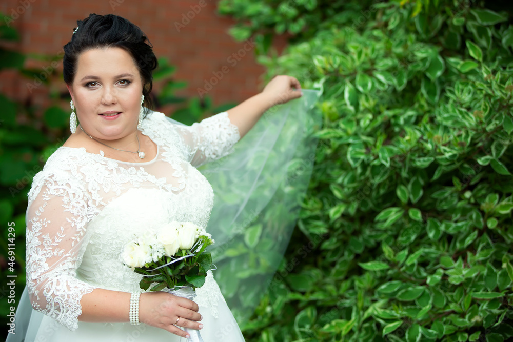 Beautiful fat bride posing in a white wedding dress. Beautiful fat bride posing in a white wedding dress.