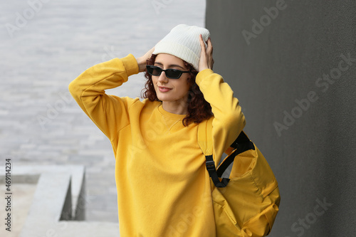 Young beautiful woman adjus...