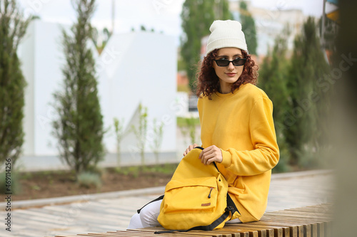 Young woman in beanie hat w...