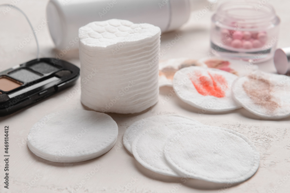 Clean and used cotton pads on light table, closeup Clean and used cotton pads on light table, closeup