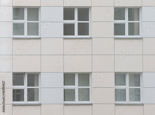 Background windows in a modern building made of tiles.