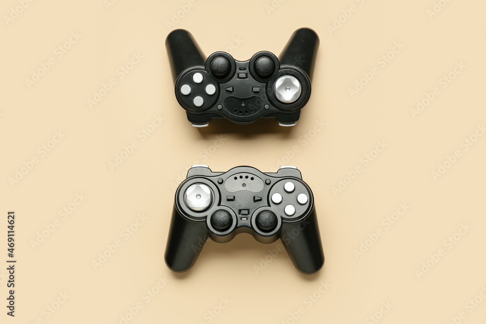 Modern joysticks on beige background Modern joysticks on beige background
