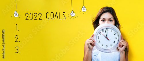 2022 goals with young woman holding a clock showing nearly 12 photo