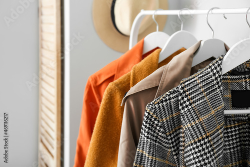 Rack with spring outwear in hallway, closeup