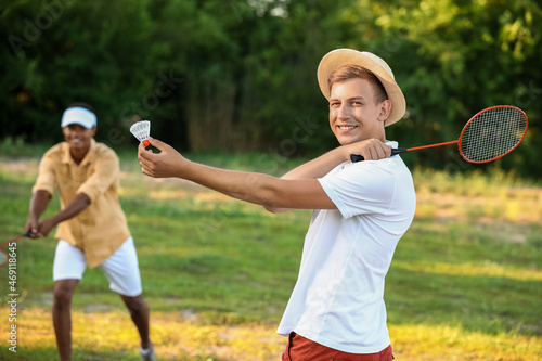 Young men playing badminton...