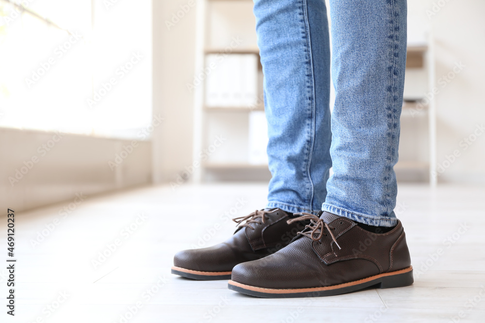 Legs of man in brown shoes at home Legs of man in brown shoes at home