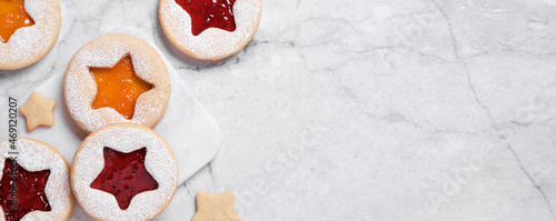 Cooking Christmas banner with traditional cookies. Linzer cookies with red and yellow jam