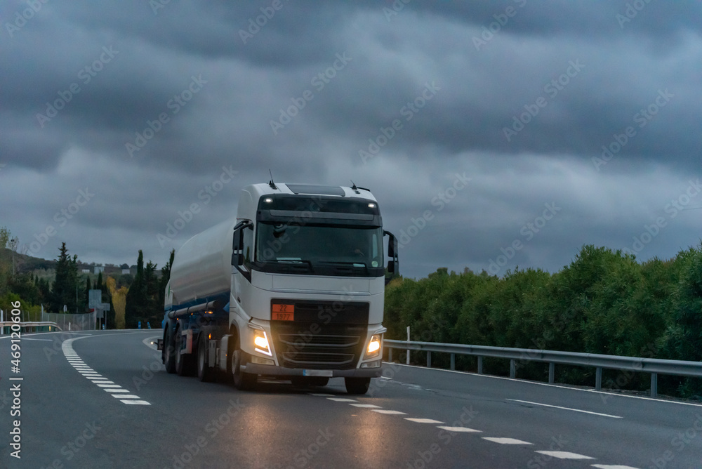Tanker truck for the transport of dangerous gases circulating on a stormy day.