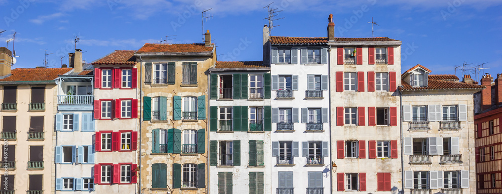Panorama of the colorful windows with shutters on houses in Bayonne, France