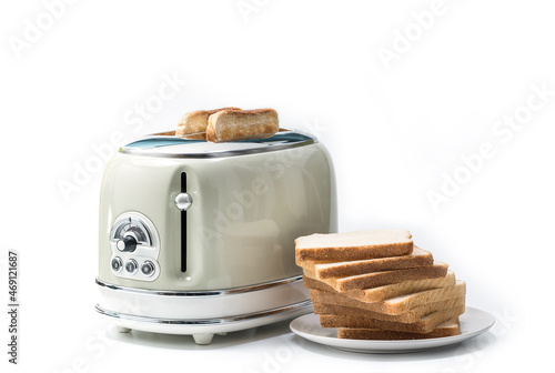 Retro toaster and a toasted slices of bread with Several slices of white bread prepared for breakfast. Crispy toast is spread on a plate isolated on white background

