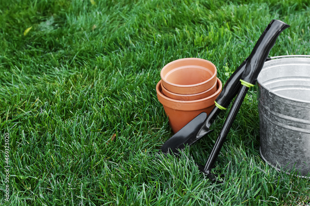 Gardening tools on green grass outdoors